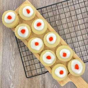 Ten identical cookies in a brown box with a clear top